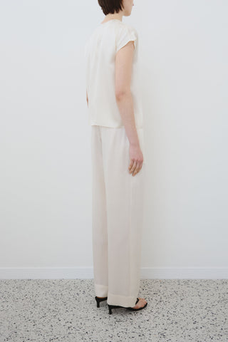 Back view of HERTH Cora short-sleeve top in almond organic silk — elegant sustainable fashion piece crafted in Italy, available at ASSOLUTO boutique.