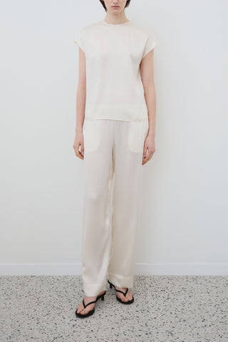 Front view of HERTH Cora short-sleeve top in almond organic silk — sustainable Italian womenswear, available at ASSOLUTO boutique.