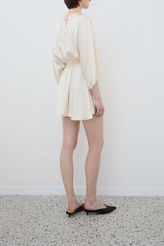 Back view of Ema mini dress in almond organic silk by HERTH — elegant sustainable dress crafted in Italy, available at ASSOLUTO boutique.