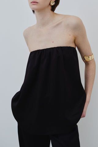 HERTH Gala off-shoulder silk top in Black, crafted in Italy from GOTS-certified organic silk. Available at ASSOLUTO boutique.