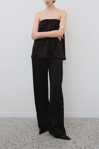 HERTH Gala off-shoulder silk top and Joy silk trousers in black — sustainable organic silk womenswear made in Italy available at Assoluto boutique.