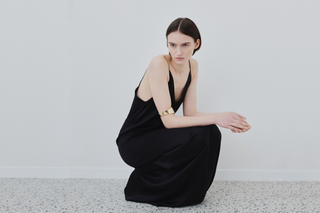 Model wearing HERTH black organic silk slip dress — contemporary Italian luxury with minimalist design and refined elegance.