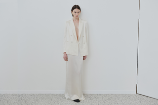 Model wearing HERTH organic silk ivory blazer and maxi skirt, crafted in Italy with timeless elegance.