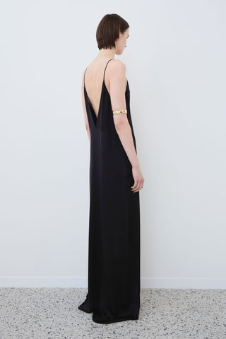 Angled view of HERTH Inez slip dress in Black organic silk — minimal sustainable eveningwear designed and crafted in Italy, available at ASSOLUTO boutique.