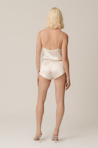 Back view of HERTH Janis short romper bodysuit in Almond organic silk — elegant sustainable womenswear made in Italy, available at ASSOLUTO boutique.