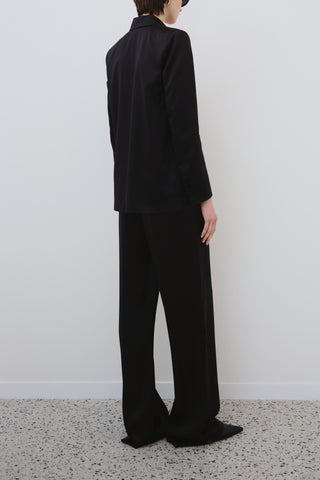 Back view of the HERTH Joy trousers paired with the Uma blazer in black. Available at ASSOLUTO boutique in Rome.