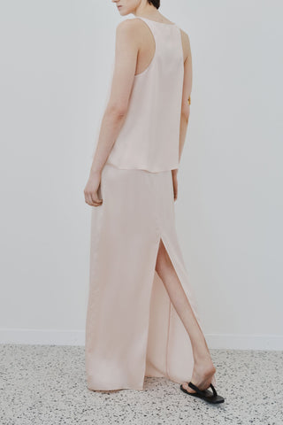 Back view of HERTH Nilde maxi skirt in Whisper Pink organic silk — refined sustainable womenswear crafted in Italy, available at ASSOLUTO boutique.