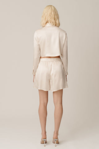 Back view of HERTH Tea cropped shirt in Almond organic silk — elegant sustainable womenswear made in Italy, available at ASSOLUTO boutique.